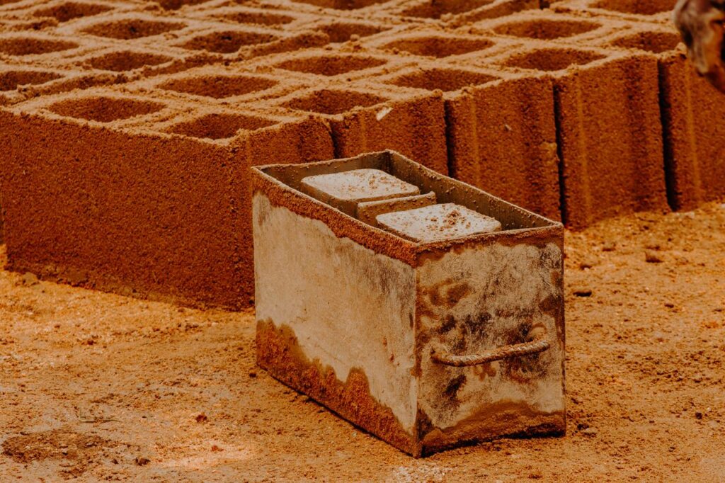 Close-up of handmade clay bricks in a construction area, highlighting traditional manufacturing techniques.