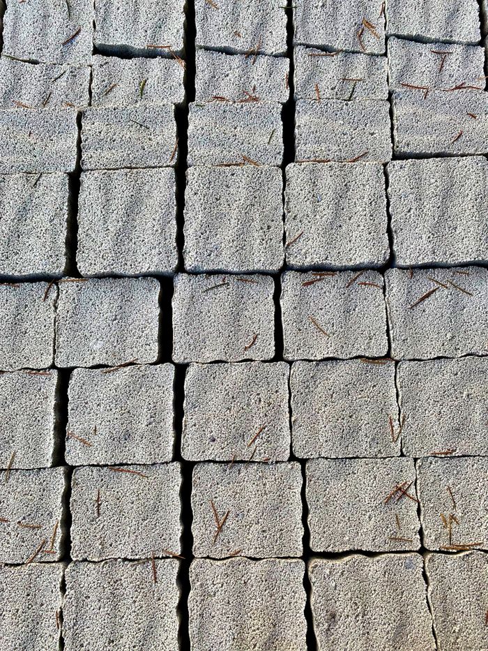 Close-up of textured concrete blocks, arranged orderly. Shows surface detail and texture.